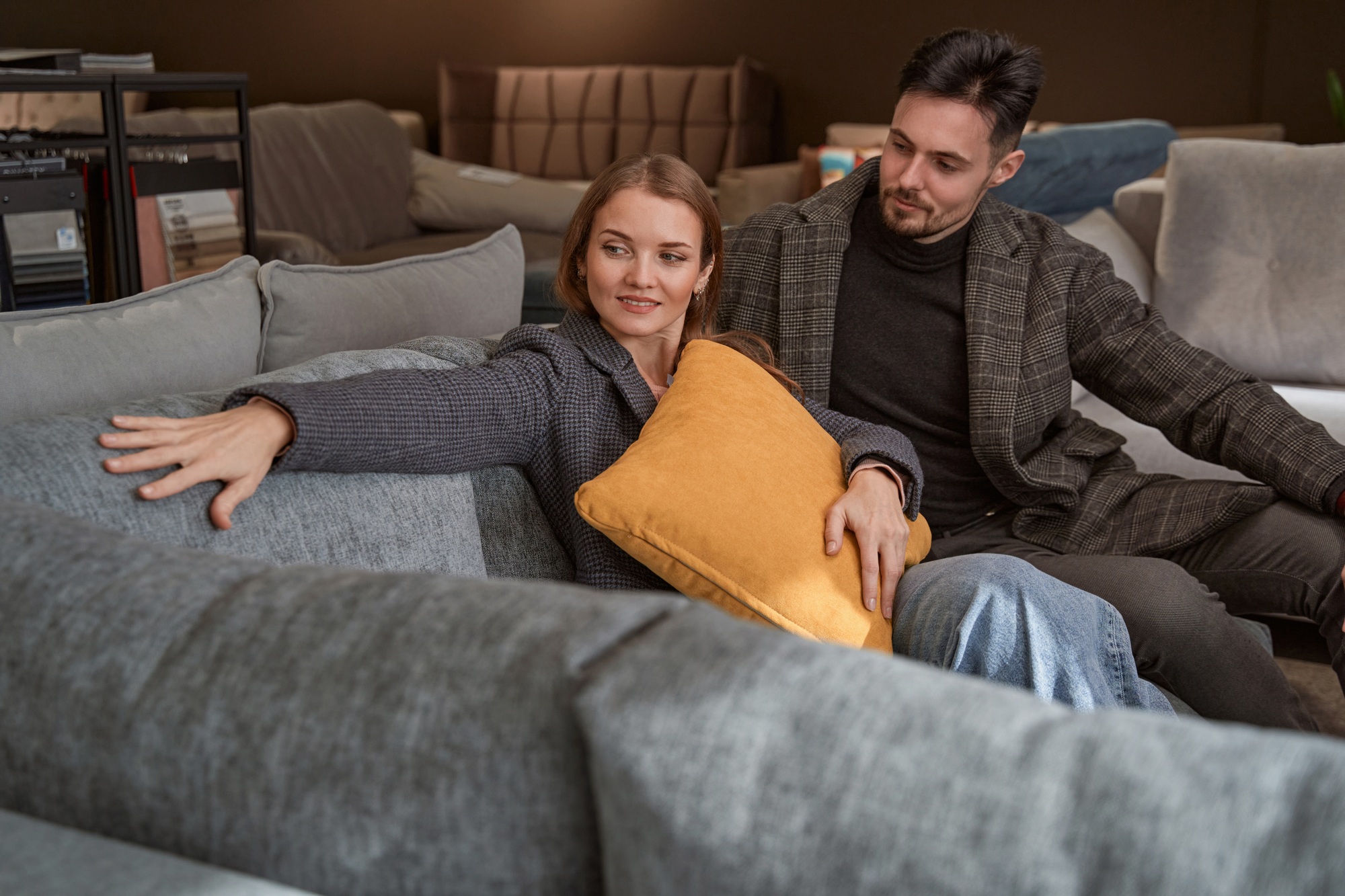 Young Caucasian couple shopping for new couch